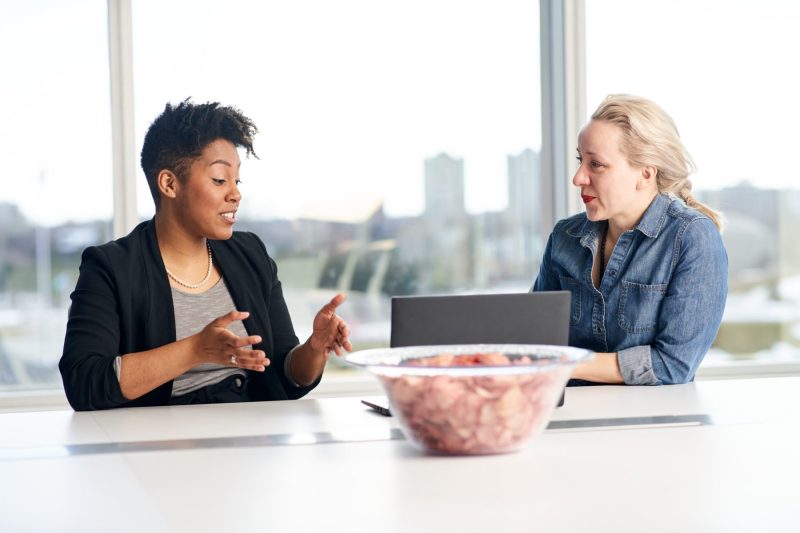 Colleagues chat over ketchup chips
