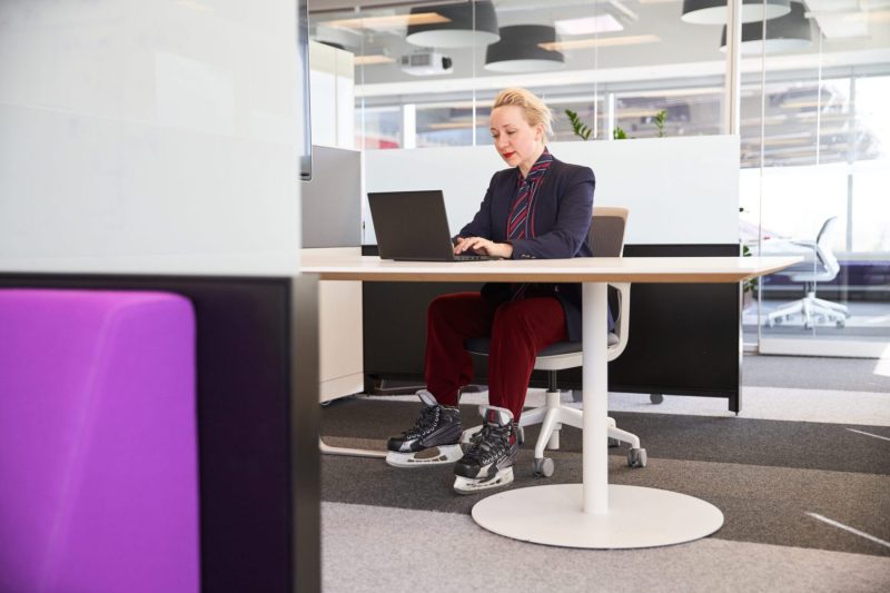 Woman in skates works on laptop