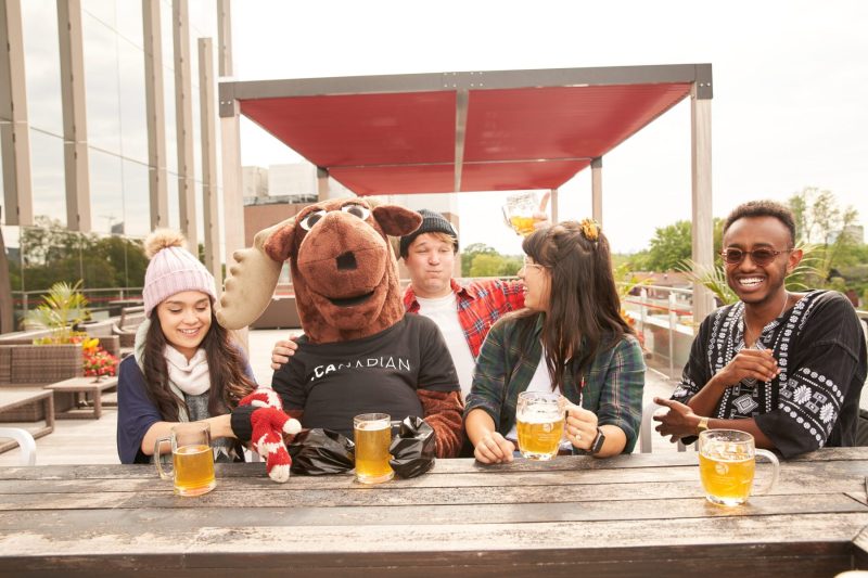 Drunk guy interrupts beer with friends