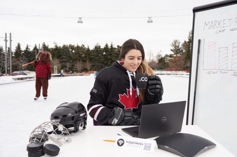 Hockey players take a break, rival looks on