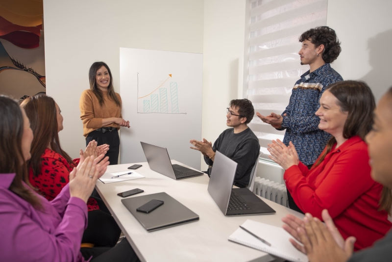Clapping for colleague after their presentation