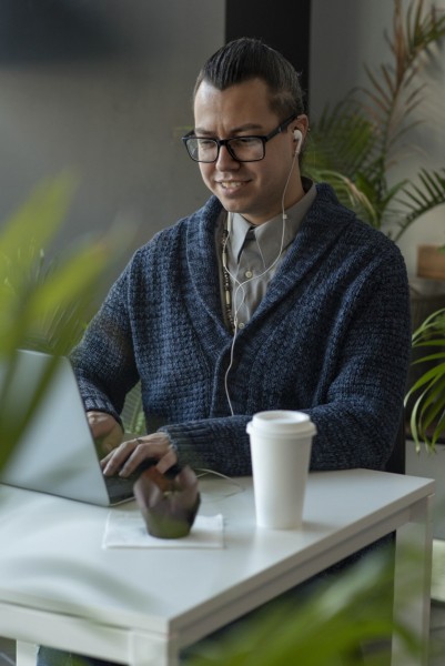 Man on a video chat while having coffee at café