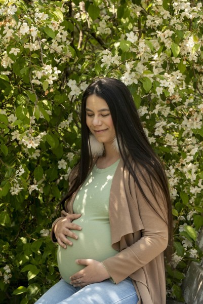 Pregnant woman surrounded by flowers