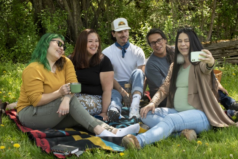 Friends having fun taking a selfie at a picnic