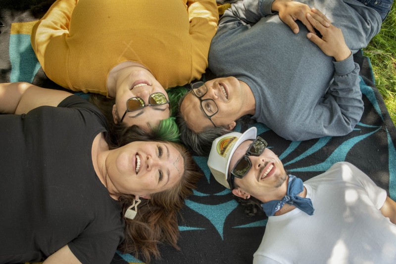 Friends laying on a picnic blanket